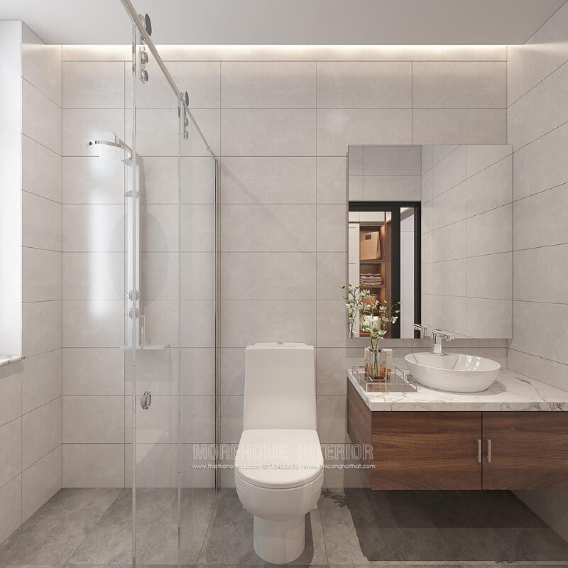 Thiết kế phòng tắm chung cư theo phong cách hiện đại đẹp với cách lựa chọn đồ vật tinh gọn nhưng lại tạo vẻ đẹp sang trọng cuốn hút từ tường ốp gạch giả bê tông, gương hình chữ nhật không khung ốp tường, phòng tắm kính cửa trượt.